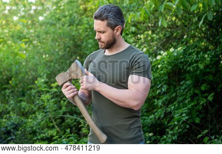 Man Holding Ax. Man With Ax Wearing Shirt. Man With Ax Outdoor. Photo Of Man With Ax