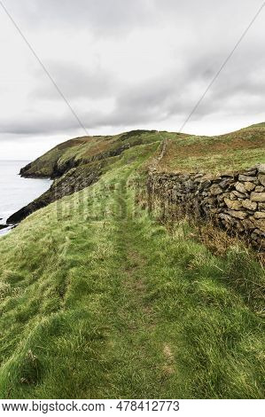Autumn Or Fall Path With  Dry Stone Wall, And Sea.