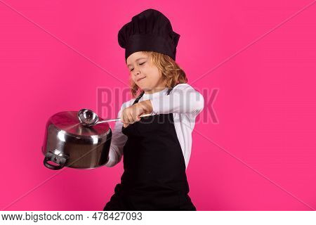 Fynny Kid Chef Cook With Cooking Pot And Ladle. Kid Chef Cook Prepares Food On Isolated Studio Backg
