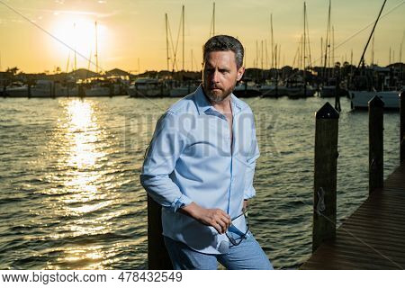 Rich Fashion Business Man Dreaming And Thinking Of Yacht. Well-dressed Fashion Man In Fashionable Ey
