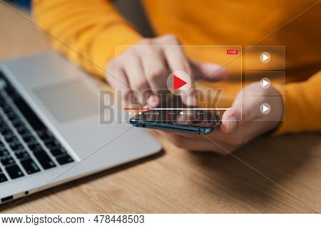 Online Movie Streaming With Smartphone. Young Man Watching A Movie On A Mobile Phone With An Imagina