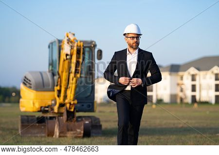 Construction Manager In Suit And Helmet At A Construction Site. Construction Manager Worker Or Super