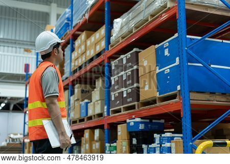 Asian Male Factory Manager Inspect Goods In Warehouse Or Inventory And Check Stock Product. Transpor