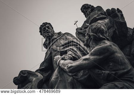 Statue Of Saints John Of Matha, Feliz Of Valois, And Ivan On Charles Bridge. Prague, Czech Republic