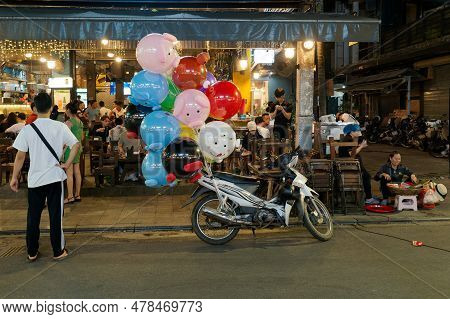 Hue, Vietnam - March 21, 2023: The Motorcycle With Fancy Balloons For Sale Parks In Front The Bar An