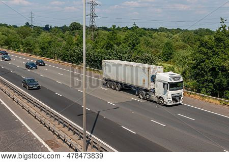 London, Uk - June 14, 2023: Lorry Carrying Refrigerated Shipping Container In Motion On British Moto