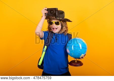 Child With Backpack And Camera, Explorer. Concept Of Exploration And Discovery. Kid Hold World Globe