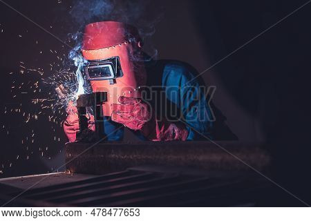 Metal Welding Steel Works Using Electric Arc Welding Machine To Weld Steel At Factory. Metalwork Man