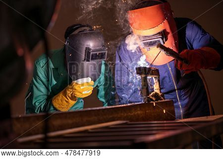 Metal Welding Steel Works Using Electric Arc Welding Machine To Weld Steel At Factory. Metalwork Man