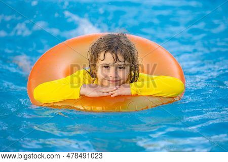 Swimming, Summer Vacation. Child Swim In Pool On Inflatable Ring. Kid With Inflatable Ring In Swimmi