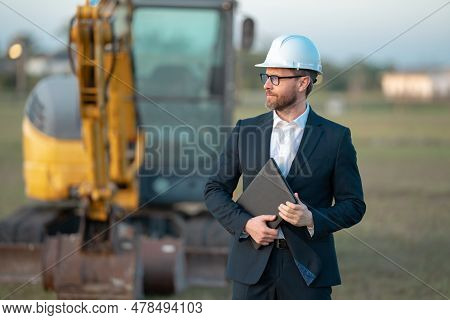 Construction Business Owner. Man In Suit And Hardhat Halmet At Building Construction Site. Civil Eng