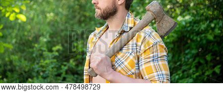 Cropped Photo Of Rancher With Axe. Rancher With Axe. Rancher With Axe Wearing Checkered Shirt
