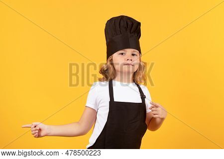 Child Chef Cook Prepares Food On Isolated Studio Background. Kids Cooking. Teen Boy With Apron And C