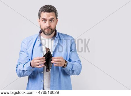 Moneyless Guy With Wallet In Studio With Copy Space. Moneyless Guy With Wallet At Hand.