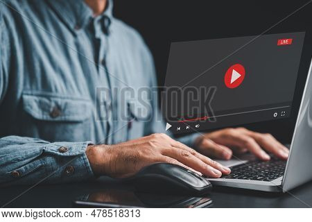 Man Using A Laptop To Stream Online Videos And Tutorials. Enjoy The Convenience Of Streaming With Ju