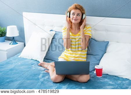 Happy Woman With Coffee Listen Music In Headphones. Woman At Home Listen To Music.
