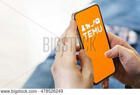 Boston, Us, March 2023: Female Hands Holding A Phone With Temu Logo Displayed On The Screen. Temu Is