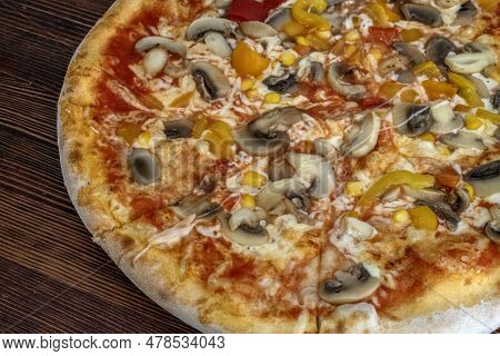 Funghi Pizza With Tomato Sauce, Cheese, Mushrooms, Peppers And Corn On Wooden Table
