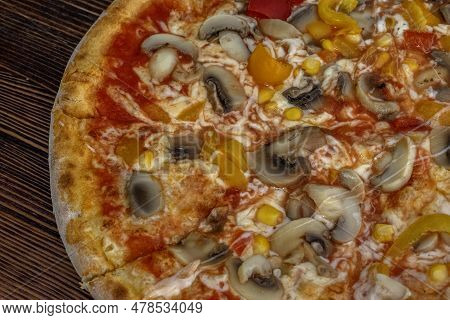 Funghi Pizza With Tomato Sauce, Cheese, Mushrooms, Peppers And Corn On Wooden Table