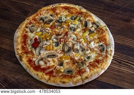 Funghi Pizza With Tomato Sauce, Cheese, Mushrooms, Peppers And Corn On Wooden Table