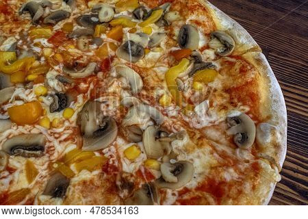 Funghi Pizza With Tomato Sauce, Cheese, Mushrooms, Peppers And Corn On Wooden Table