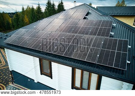 Aerial View Of New Modern House Cottage With Solar Photovoltaic Panel System On Roof. Concept Of Alt