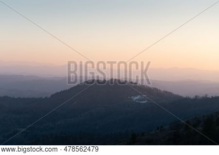 Landscape With Hill Overgrown In Forest Against Mountain Layers Fading In Distance, View From Mounta