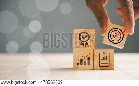 Businessmans Hand Skillfully Arranging Wood Blocks, Signifying A Business Strategy And Action Plan. 