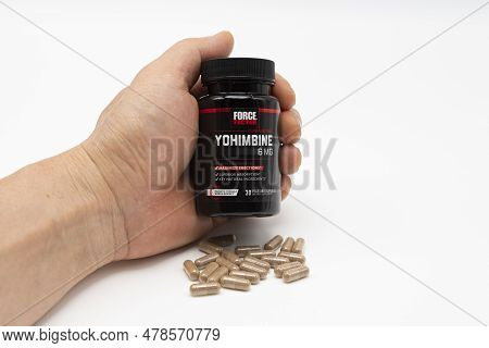 Fuji, Shizuoka, Japan - April 26, 2023: Hand Holding Yohimbine Force Factor 6 Mg Bottle With Scatter