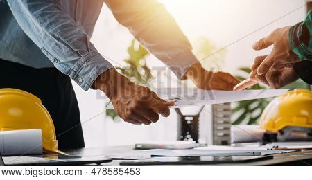 Architect Having A Meeting With Construction Team On Site