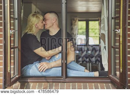 Skjern, Denmark, May 21, 2023: A Married Couple Kissing In Their House