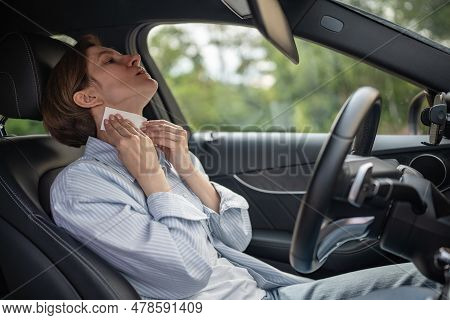 Woman Drives Car With Broken Air Conditioning In Hot Summer Weather Wipes Sweat Paper Napkin. Middle