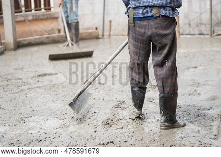 Skilled Builder Expertly Pours Cement On The Floor, Sculpting A Solid Foundation For The House With 