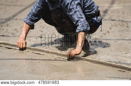 Skilled Builder Expertly Pours Cement On The Floor, Sculpting A Solid Foundation For The House With 