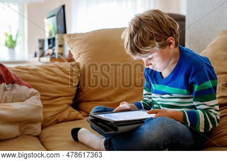 School Boy With Tablet Computer. Schoolchild Study Online. Electronic Device For Learning, Studying 