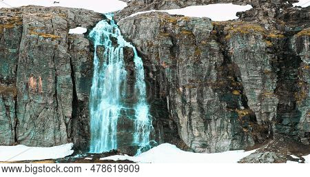 Aurlandsfjellet, Norway. Waterfall Flotvatnet In Spring Snowy Landscape. Natural Norwegian Landmark 