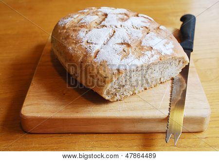 Sourdough On Chopping Board With Knife