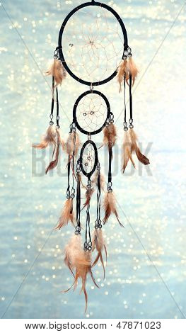 Beautiful dream catcher on blue background with lights