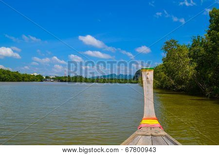 Wooden Long Tailed Boat Across River