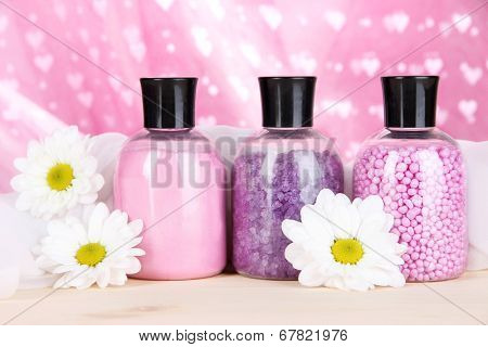 Aromatherapy minerals - colorful bath salt on pink background