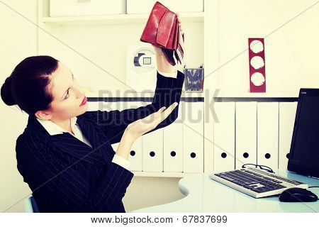 business woman is holding empty wallet, in office.Bankruptcy concept.