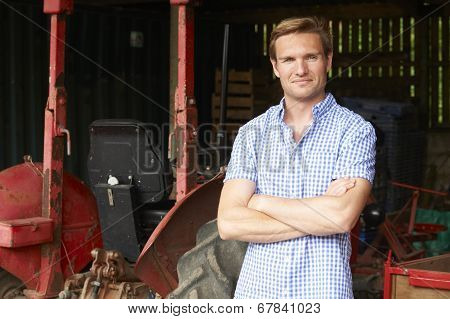 Portrait Of Farmer With Old Fashioned Tractor
