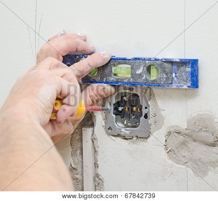 Certified Electrician Installing Socket For Light Switch.