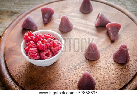 Cuberdons With Fresh Raspberries On The Wooden Board