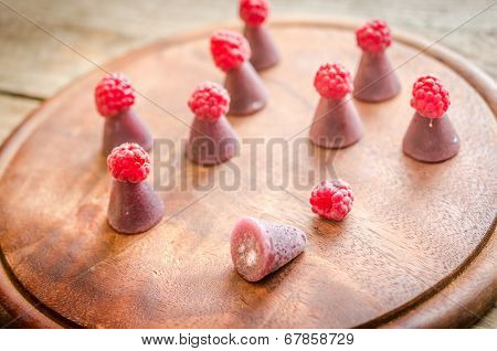 Cuberdons With Fresh Raspberries On The Wooden Board