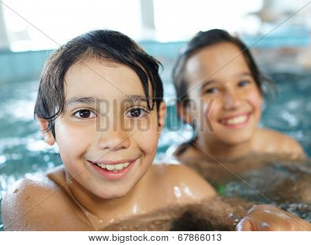 Happy little boys enjoying relaxing and splashing in water