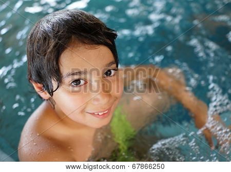 Happy little boys enjoying relaxing and splashing in water