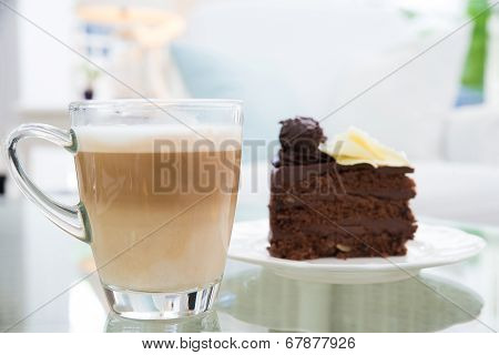 Latte Coffee Cup And  Chocolate Cake In Background