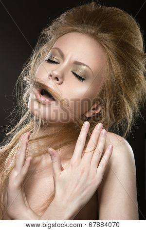 Beautiful red-haired girl with perfect skin and an unusual hairstyle.