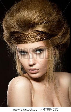 Beautiful red-haired girl with perfect skin and an unusual hairstyle.